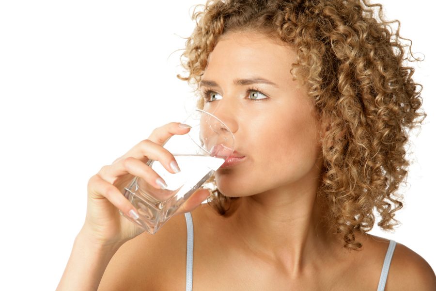 Woman drinking fresh spring water