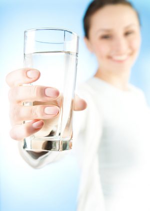 Woman offering a glass of water