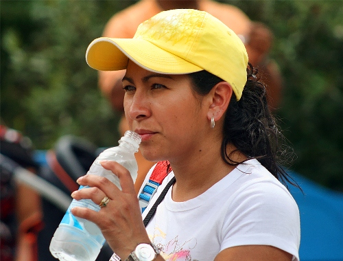 Woman drinks bottled water from Brisbane vendor