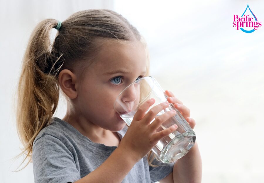 Young girl drinking a glass of water