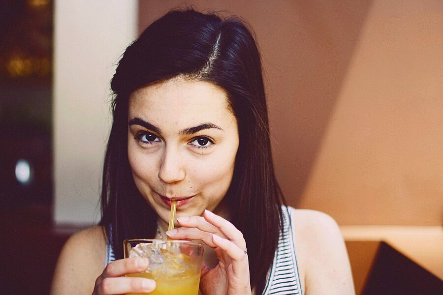 Woman sipping a cold drink